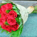 BOUQUET ~ classic red roses with Koala Fern™ and Umbrella Fern™ collar, lotus leaf wrap